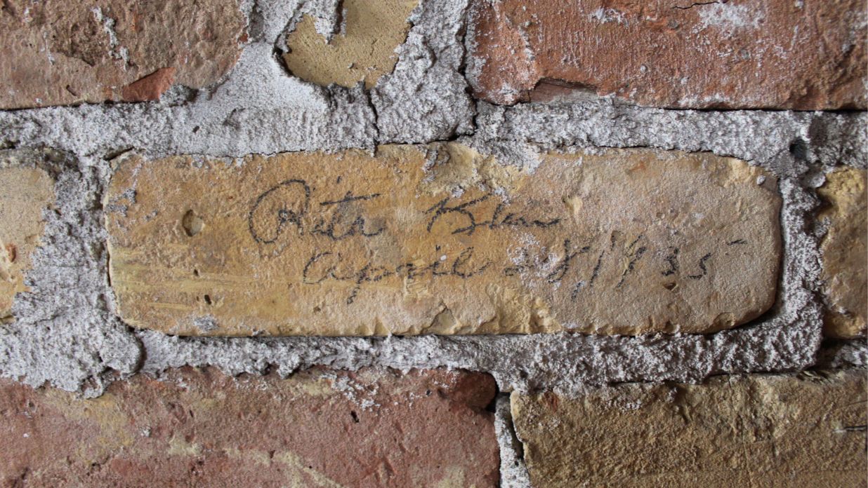 Graffiti on brick walls in the tower of the 1889 Courthouse of The Tower Heritage Center